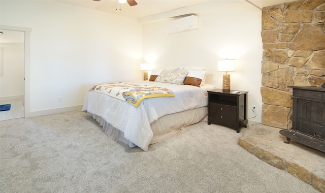 carpeted bedroom featuring a wall mounted air conditioner and ceiling fan