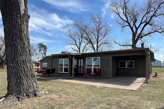 back of property with a patio, a yard, and central air condition unit