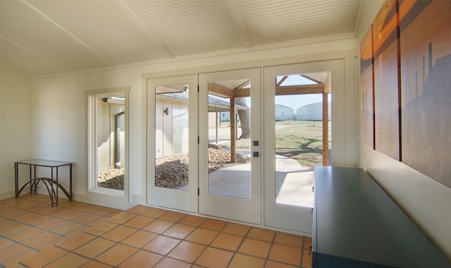 doorway featuring a healthy amount of sunlight, french doors, tile floors, and vaulted ceiling with beams