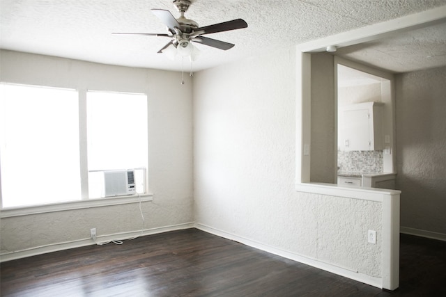 unfurnished room featuring ceiling fan, dark wood-type flooring, and a textured ceiling