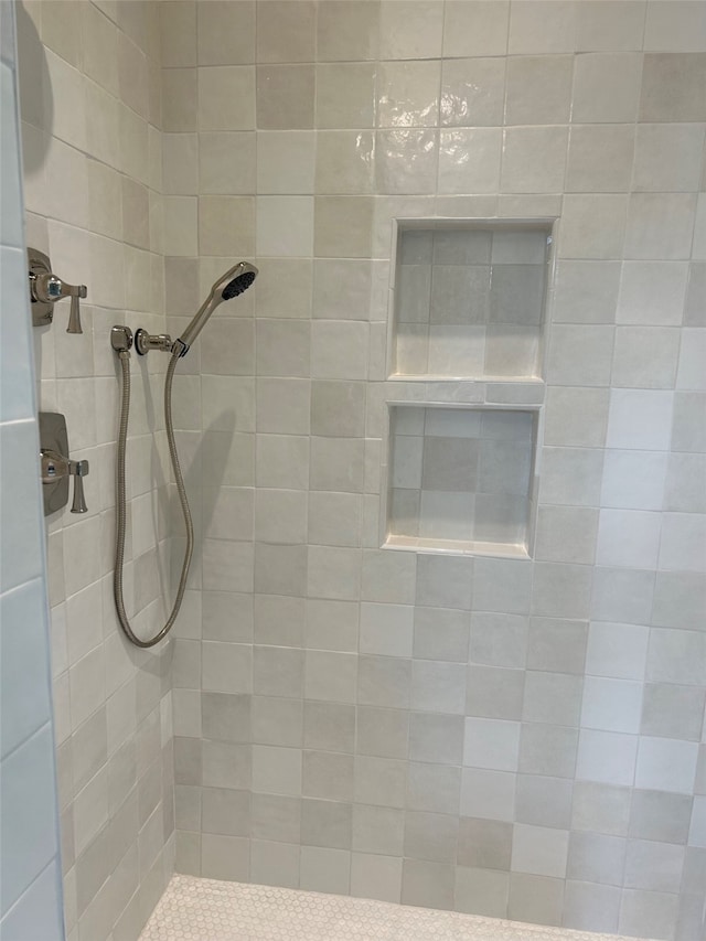 bathroom with a tile shower