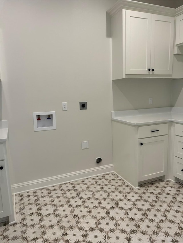 washroom with hookup for a washing machine, light floors, baseboards, hookup for an electric dryer, and cabinet space