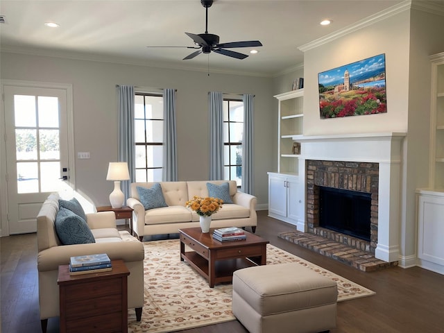 living area featuring recessed lighting, a fireplace with raised hearth, wood finished floors, and ornamental molding