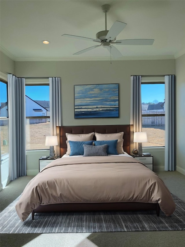 bedroom featuring carpet flooring, ceiling fan, crown molding, and baseboards