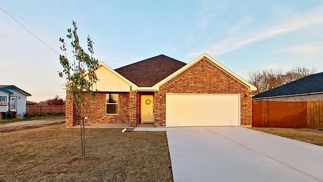 single story home with a front yard and a garage