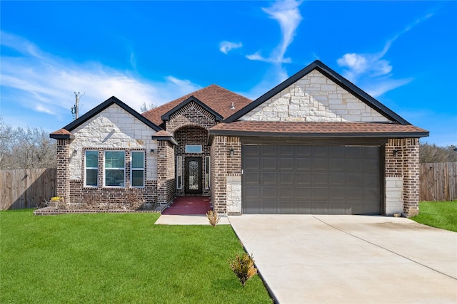 view of front of property featuring a garage and a front yard