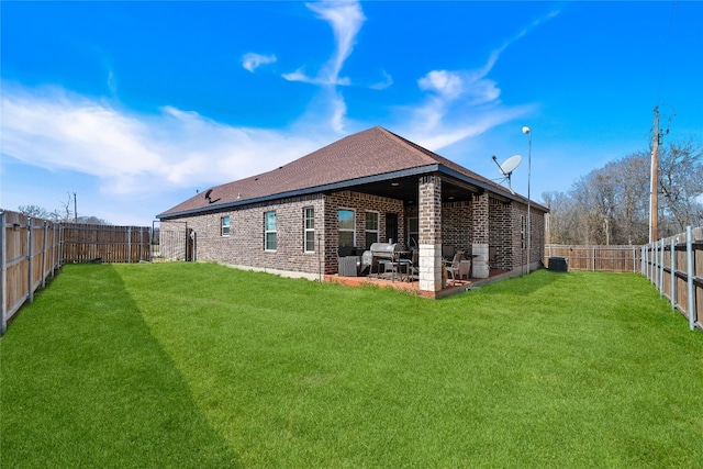 back of property with a patio area and a lawn