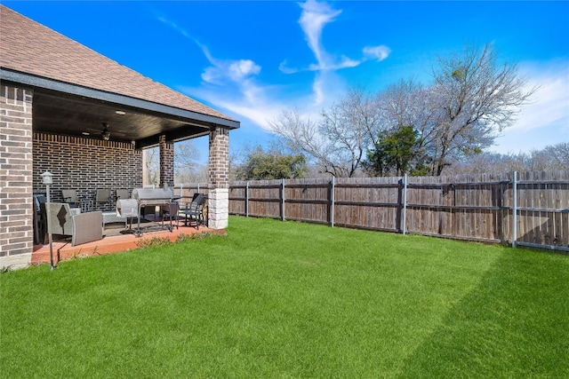 view of yard featuring a patio, ceiling fan, and outdoor lounge area