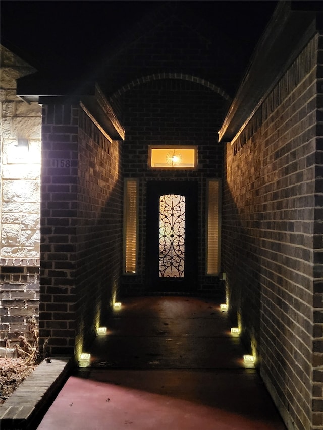 view of exterior entry at night