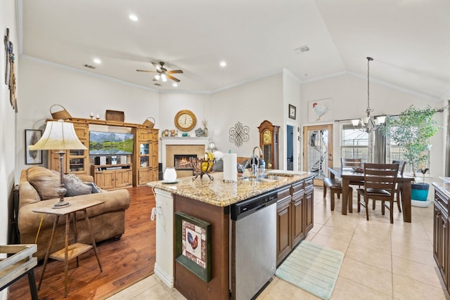 kitchen featuring sink, ornamental molding, stainless steel dishwasher, light stone countertops, and ceiling fan with notable chandelier