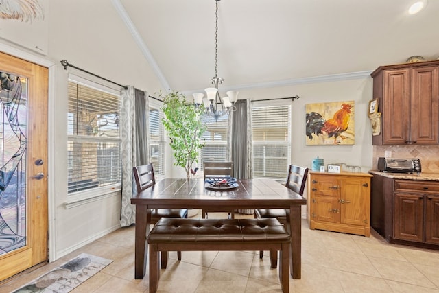 tiled dining space with lofted ceiling, a chandelier, and crown molding