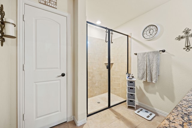 bathroom featuring tile flooring and an enclosed shower