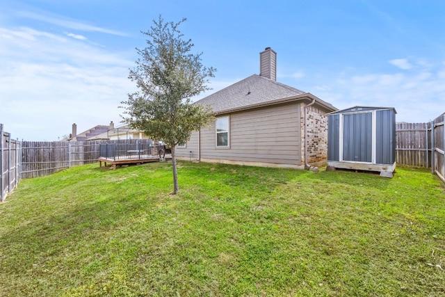 view of yard with a deck and a storage unit