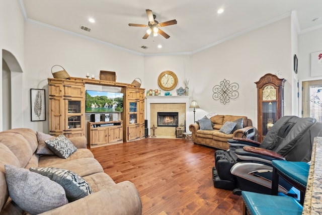 living room with a wealth of natural light, ceiling fan, dark hardwood / wood-style flooring, and ornamental molding