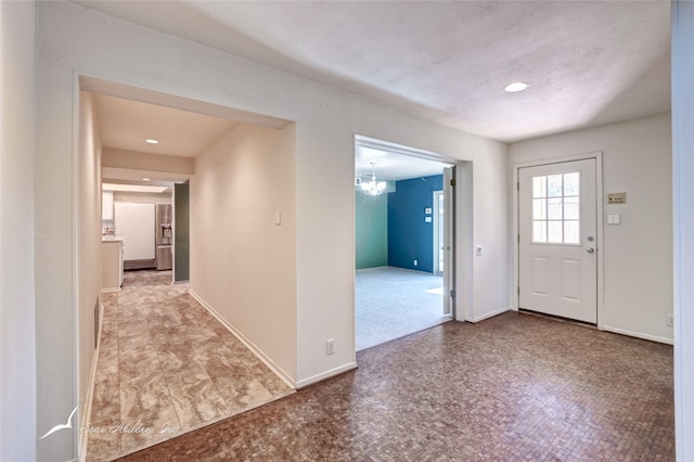 entryway with light tile floors and a notable chandelier