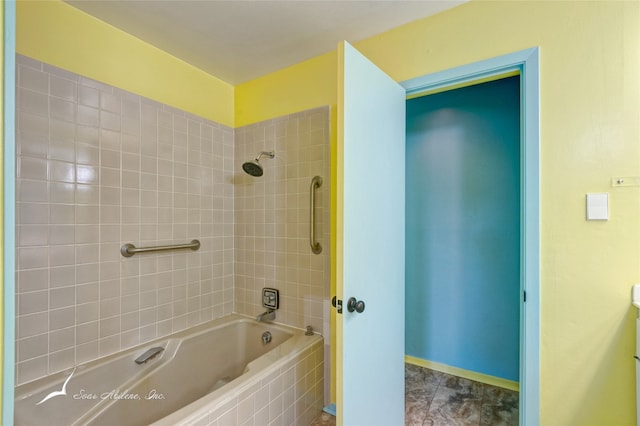 bathroom with tiled shower / bath combo and tile floors