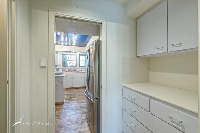 kitchen featuring light tile floors and stainless steel refrigerator