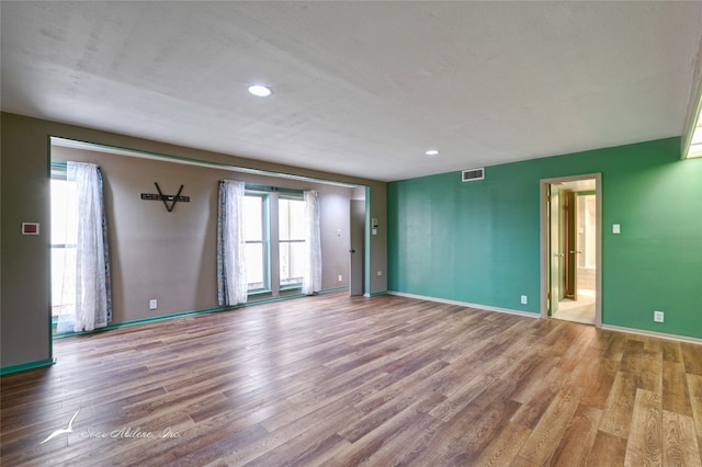 spare room with hardwood / wood-style floors