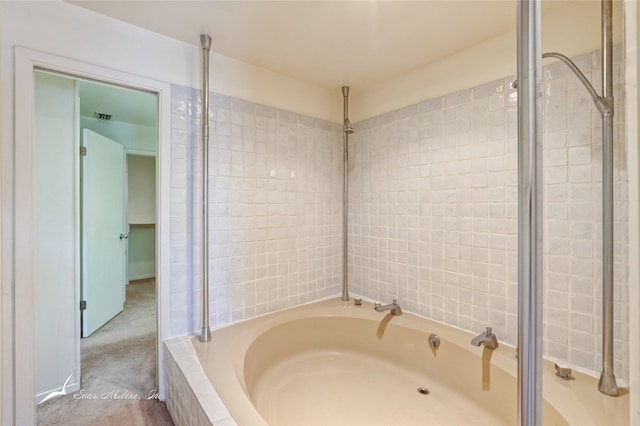 bathroom with tiled tub