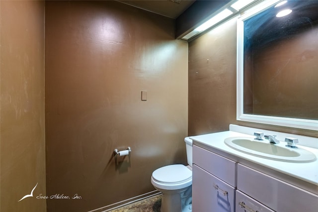 bathroom with toilet and vanity