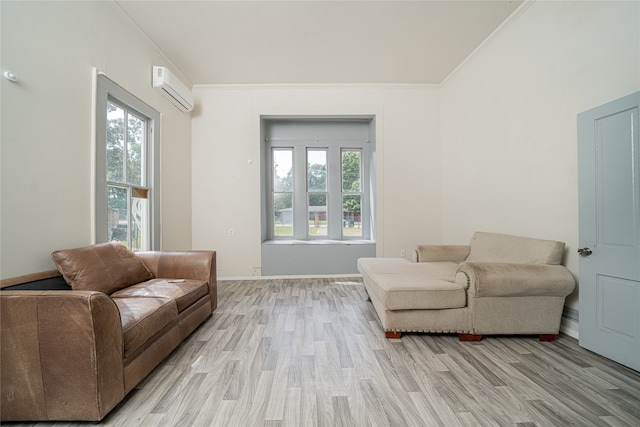 living room featuring crown molding, light hardwood / wood-style flooring, and a wall unit AC