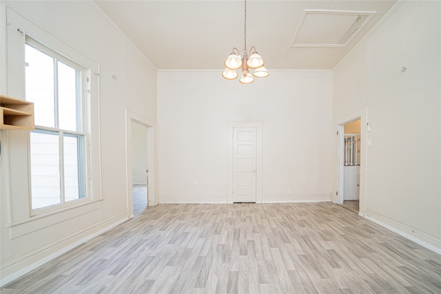 spare room featuring a wealth of natural light, light hardwood / wood-style floors, and crown molding