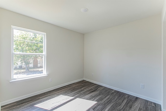 empty room with hardwood / wood-style flooring and plenty of natural light