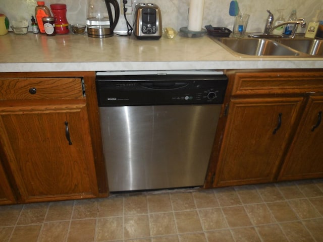 kitchen with stainless steel dishwasher, sink, and decorative backsplash