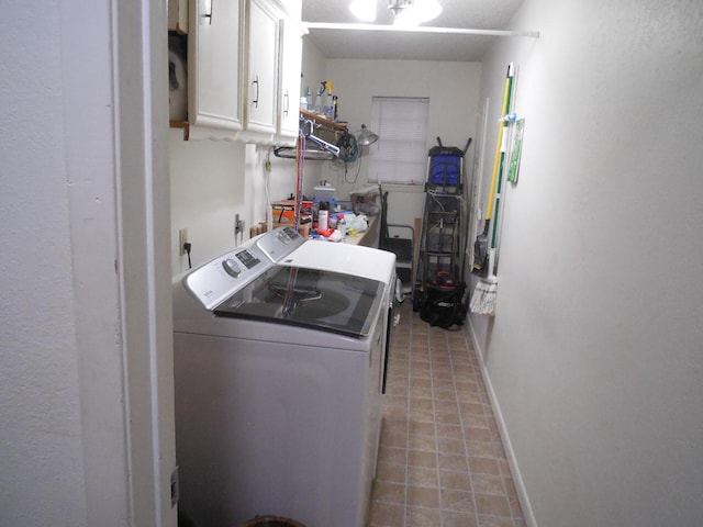 laundry room featuring cabinets and washer and clothes dryer