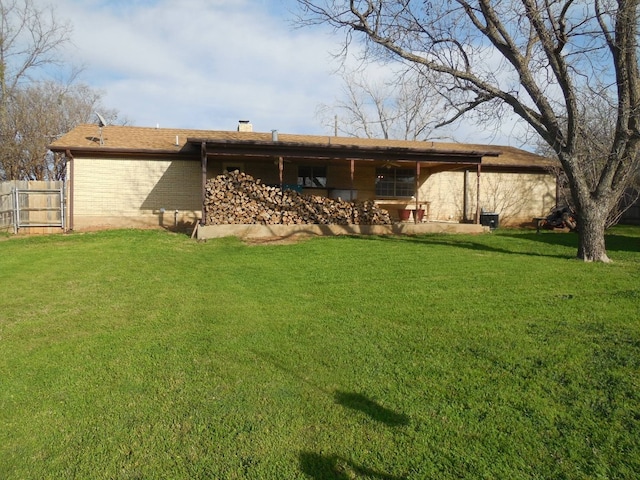 back of house with a lawn