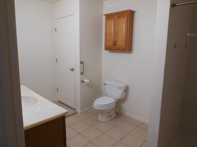 bathroom featuring vanity, tile patterned flooring, and toilet