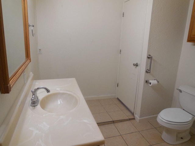 bathroom featuring vanity, toilet, and tile patterned flooring