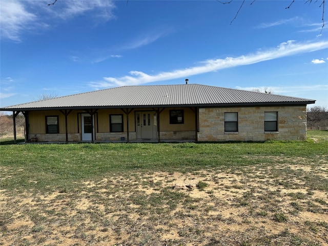 rear view of property with a yard