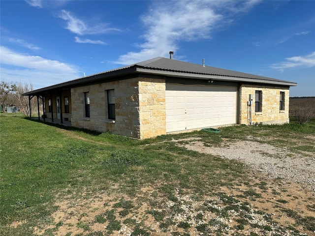 view of side of home featuring a yard and a garage