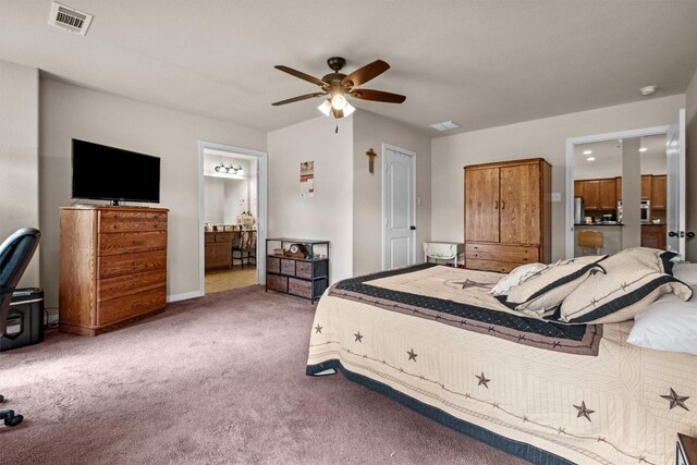 carpeted bedroom with ceiling fan and ensuite bathroom