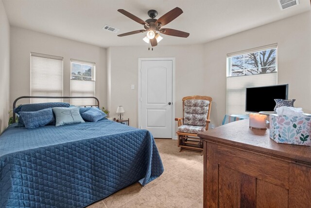 bedroom featuring ceiling fan and light tile floors