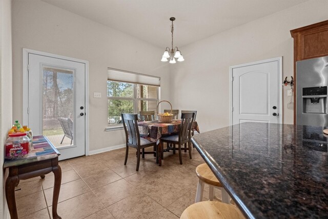 tiled dining area featuring an inviting chandelier