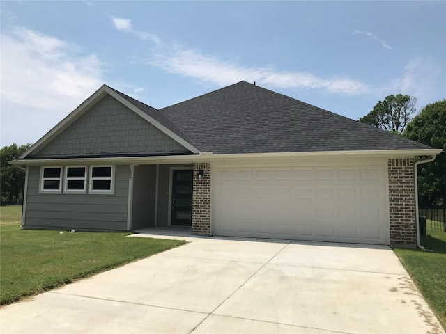 view of front of property featuring a garage and a front yard