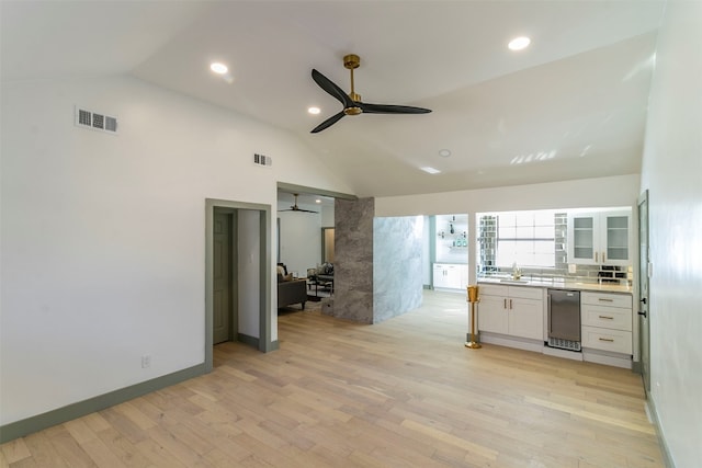 unfurnished bedroom with wine cooler, high vaulted ceiling, ceiling fan, and light wood-type flooring