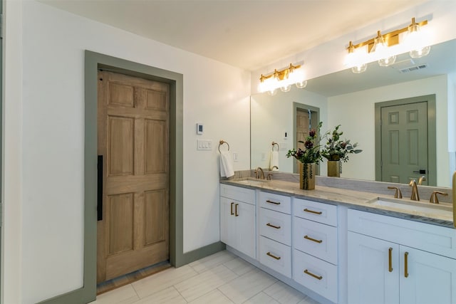 bathroom featuring tile floors and double vanity