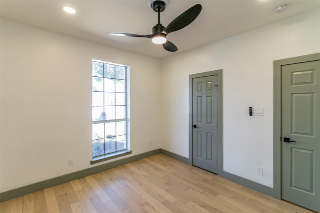 empty room featuring light hardwood / wood-style flooring and ceiling fan