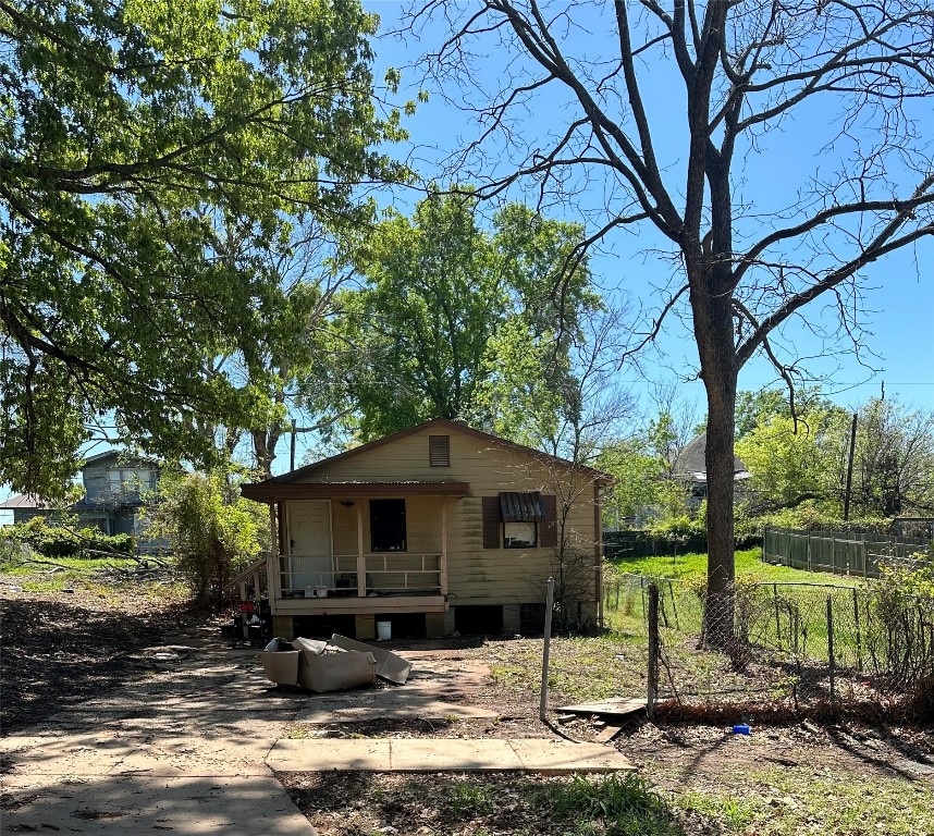 back of property featuring covered porch