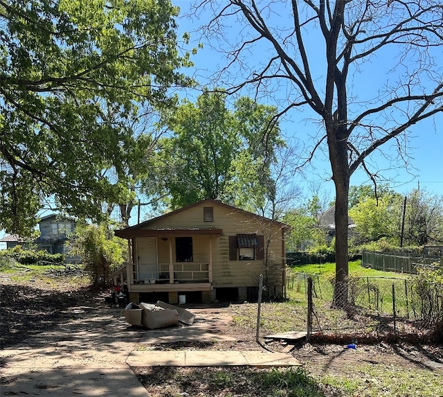 back of property featuring covered porch