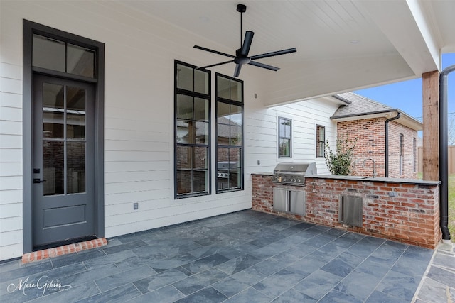 view of patio / terrace featuring exterior kitchen, area for grilling, and ceiling fan