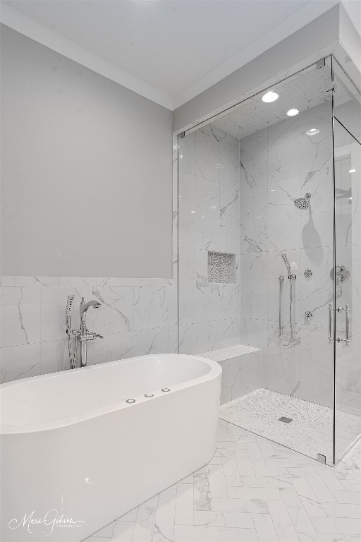 bathroom with tile walls, ornamental molding, tile floors, and plus walk in shower