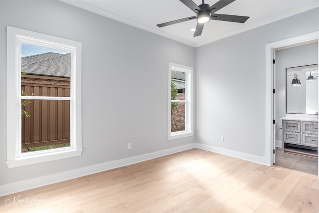 unfurnished bedroom with ceiling fan, ensuite bath, ornamental molding, and light hardwood / wood-style floors