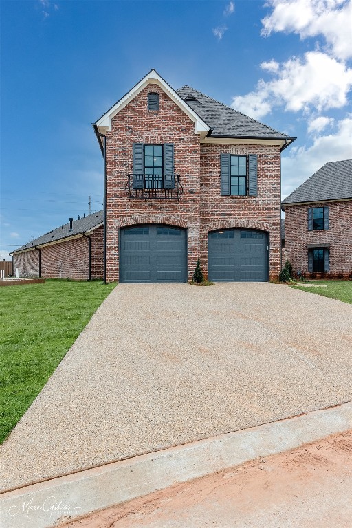 front of property with a front lawn and a garage