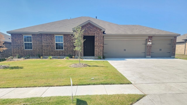 ranch-style home with a garage and a front lawn