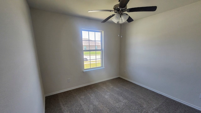 carpeted spare room featuring ceiling fan