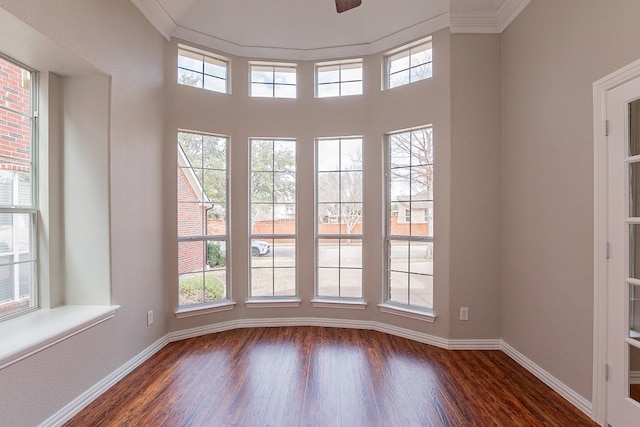 spare room featuring ceiling fan, ornamental molding, and dark hardwood / wood-style floors